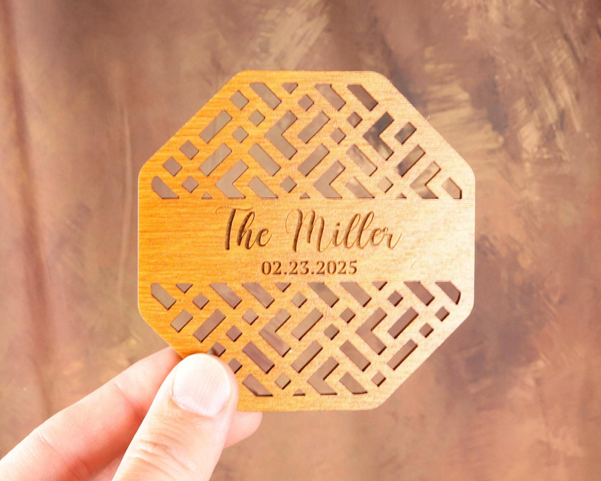 a person holding up a laser engraved wooden coaster