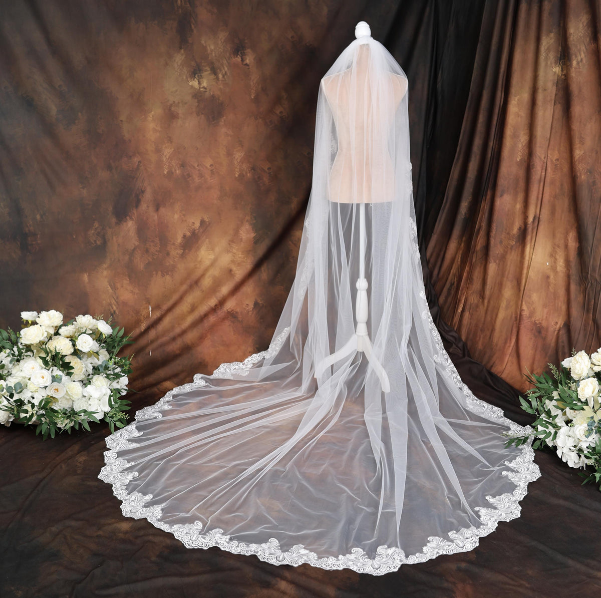a wedding veil with flowers on a table