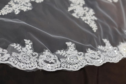 a close up of a white lace on a black cloth