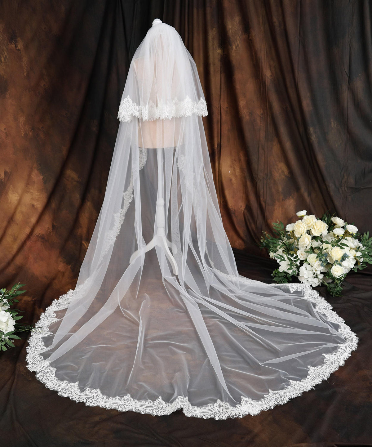 a white wedding veil with a lace edge