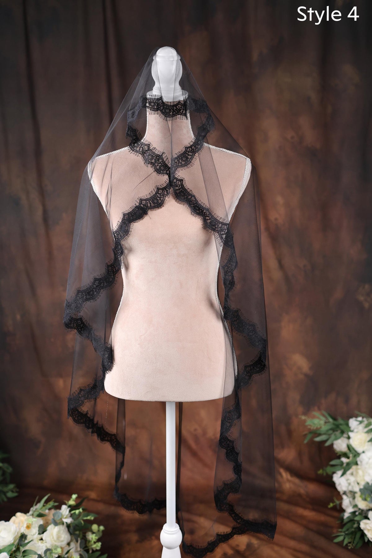 a white mannequin with a black veil on top of it