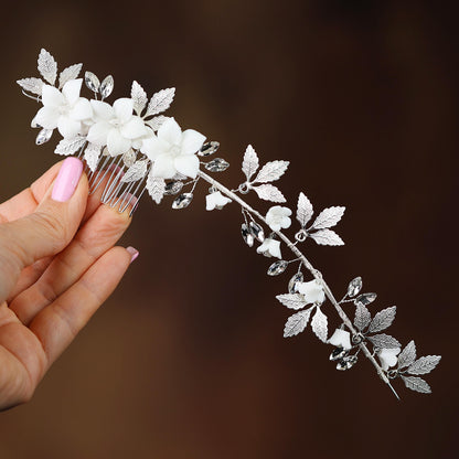 a woman holding a white flower and a silver comb