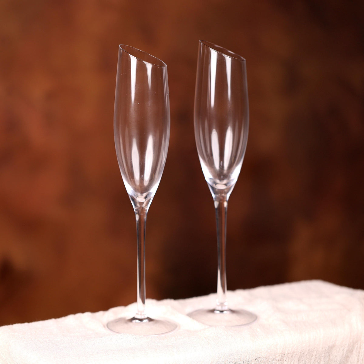two wine glasses sitting on top of a table