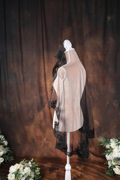 a white mannequin with black lace on it