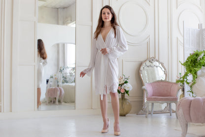 a woman standing in front of a mirror in a room