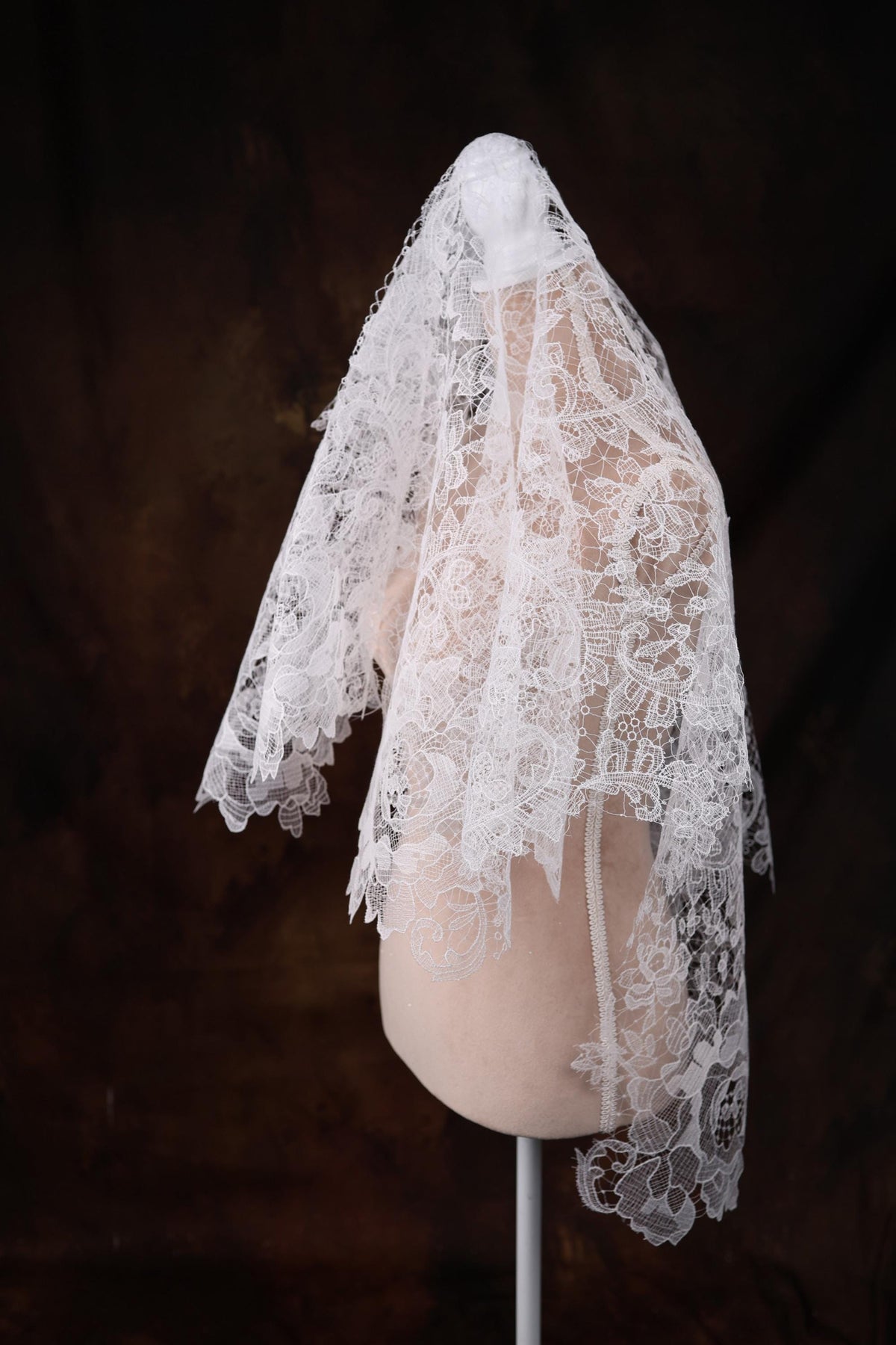 a mannequin with a white veil on top of it