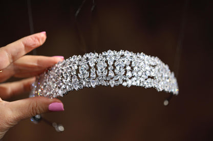 a close up of a person holding a tiara