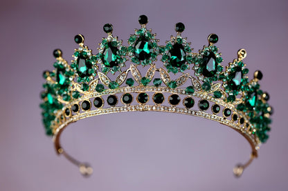 a tiara with green and black stones on it