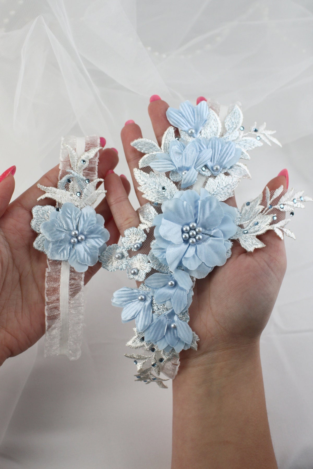 a pair of hands holding a bouquet of flowers