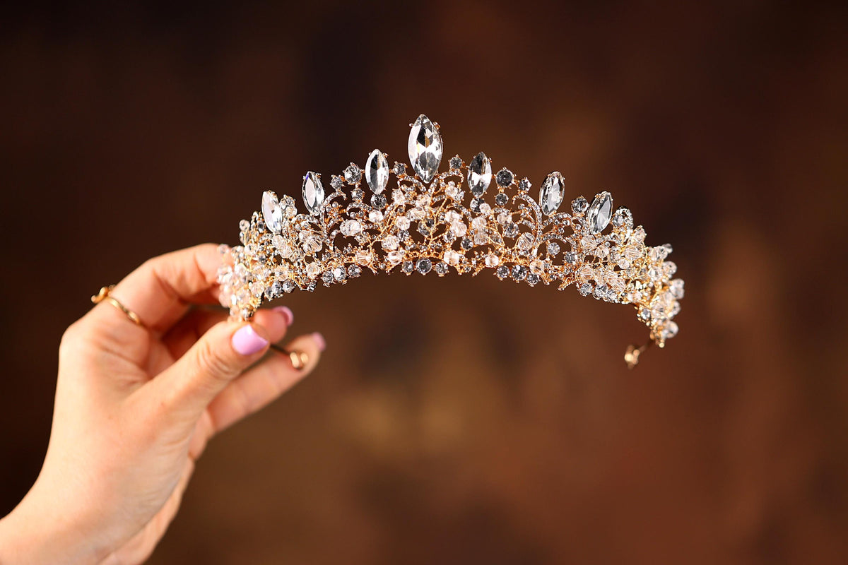 a woman holding a tiara in her hand