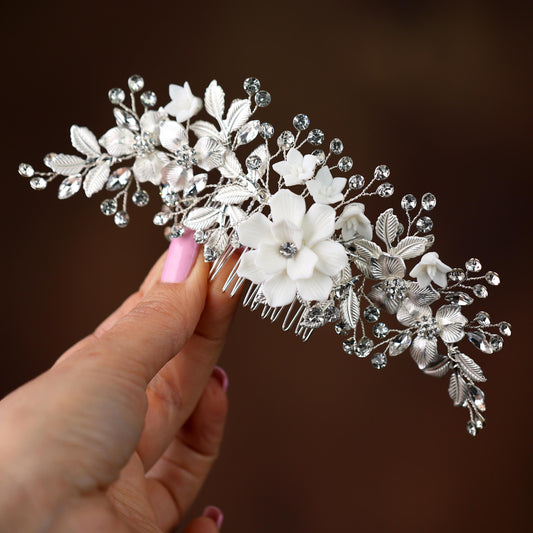 a close up of a person holding a hair comb