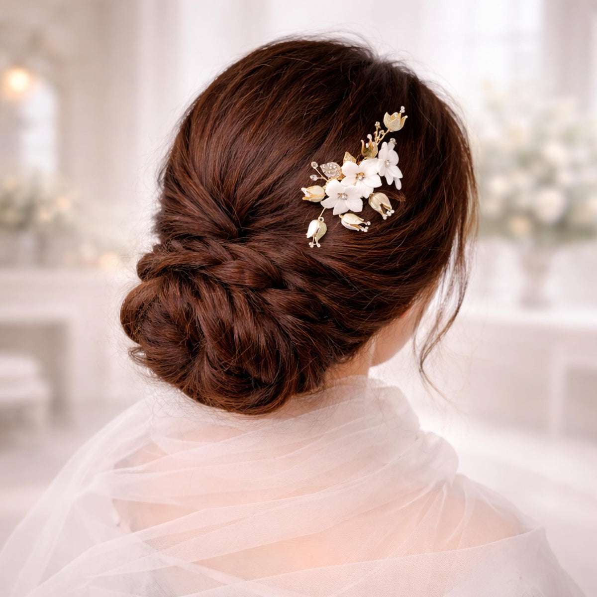 a woman's back view with her hair styled in a bun and adorned with a decorative flower accessory.