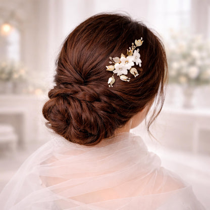 a woman's back view with her hair styled in a bun and adorned with a decorative flower accessory.