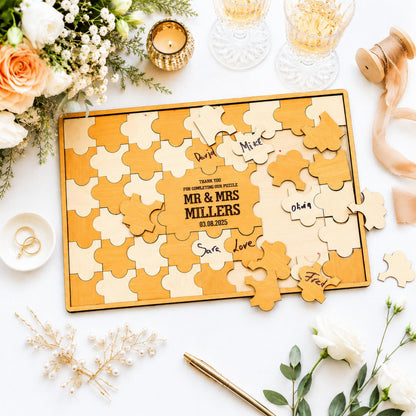 a wooden puzzle with the names of the bride and groom written on it, surrounded by various wedding-related items such as flowers, glasses, and a pen.