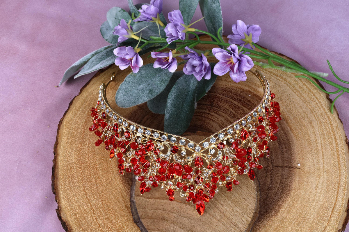 a red beaded necklace on a piece of wood