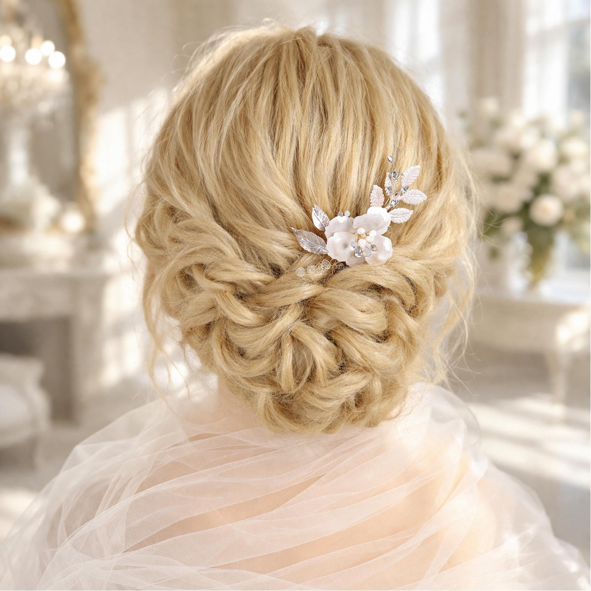 a woman's blonde hair styled in an elegant updo, adorned with a delicate flower accessory.