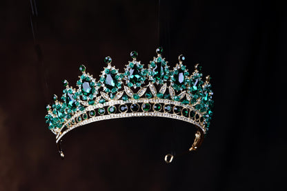 a green tiara hanging from a hook