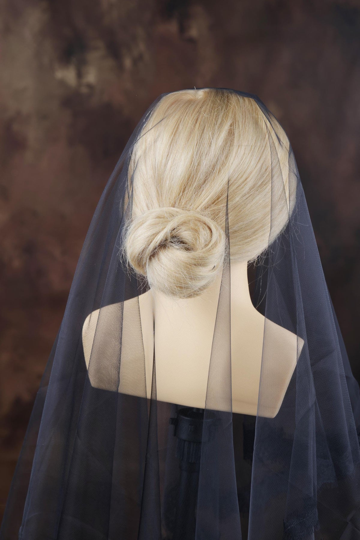 a mannequin with a veil on top of it
