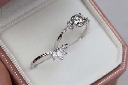 a close up of a person holding a ring in a box