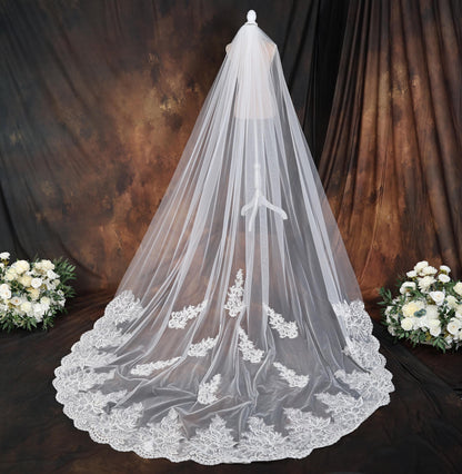 a bridal veil with a bouquet of white flowers