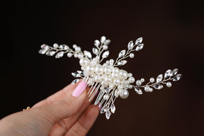 a person holding a hair comb in their hand