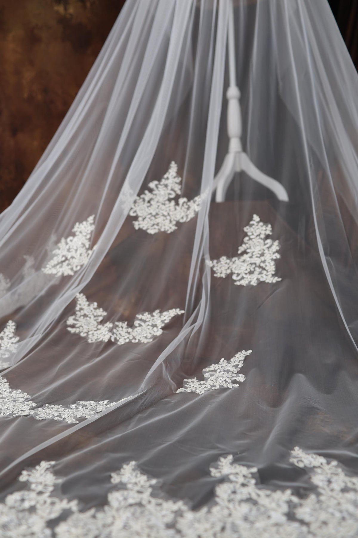 a wedding veil with white flowers on it
