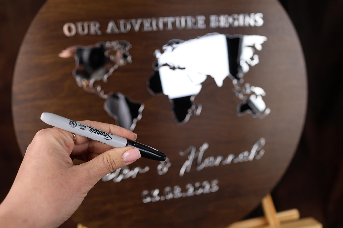 a person holding a pen in front of a world map
