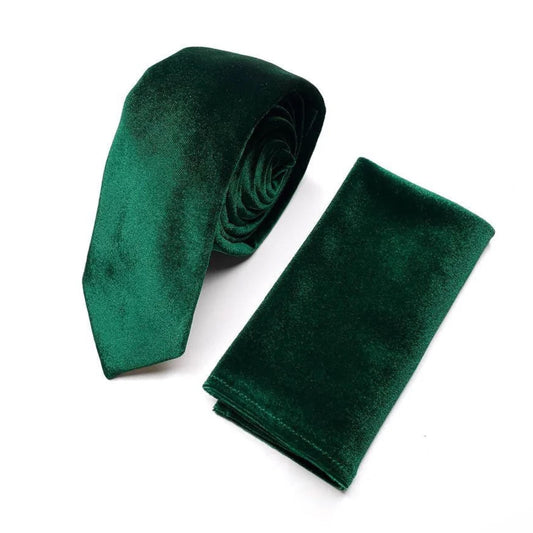 A dark green velvet tie and a dark green velvet napkin are displayed against a white background.