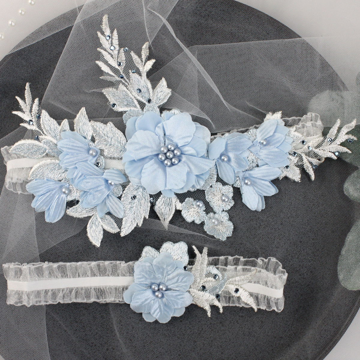 a couple of blue flowers on top of a black plate