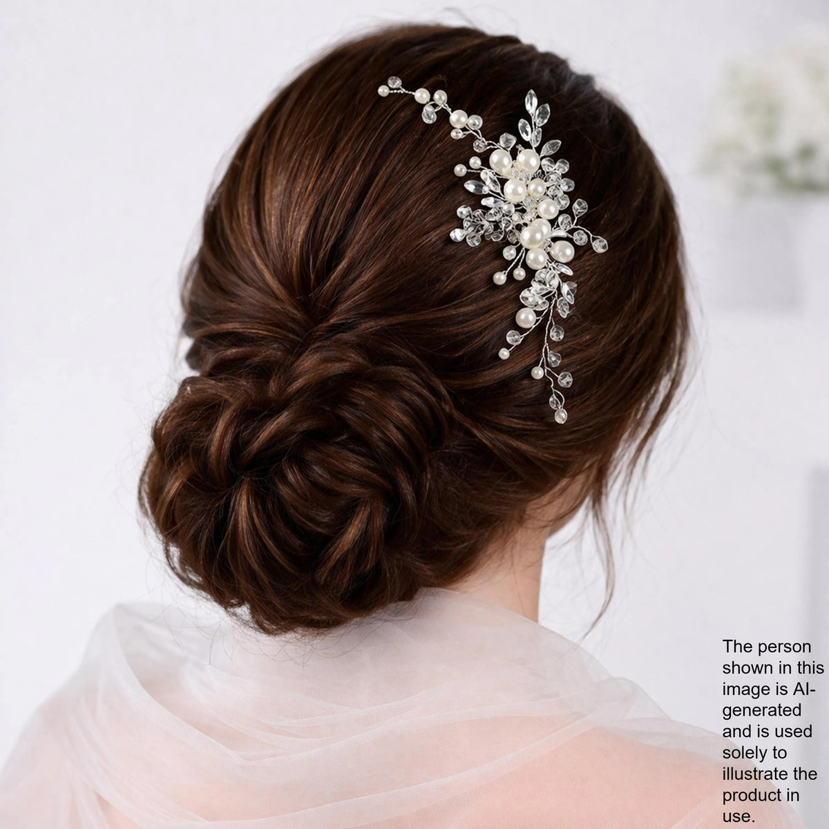 a woman's back view with her hair styled in a bun, adorned with a decorative hair accessory featuring small pearls and crystals.