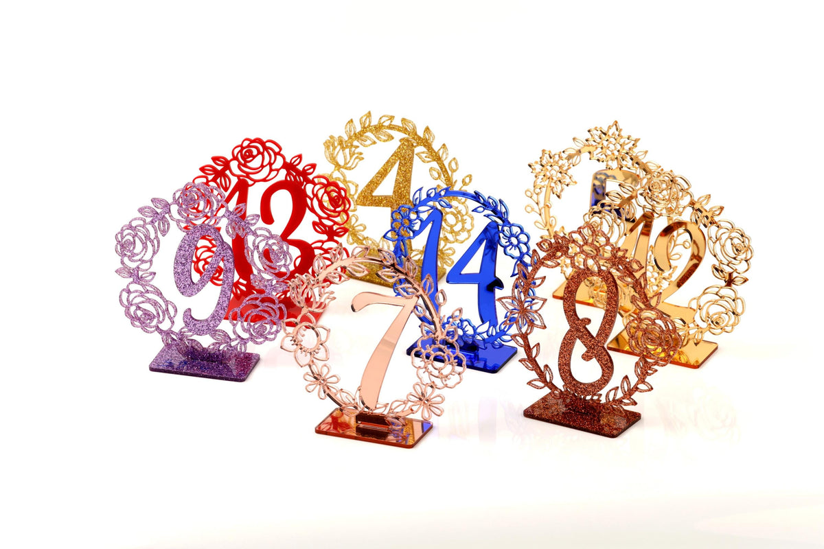 a collection of decorative table number stands, each with a unique design and color.