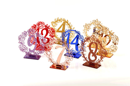 a collection of decorative table number stands, each with a unique design and color.