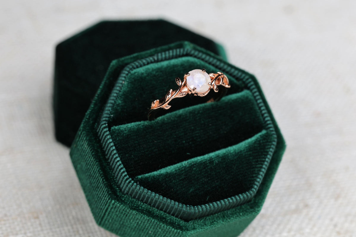 a close up of a ring in a velvet box