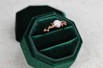 a close up of a ring in a velvet box