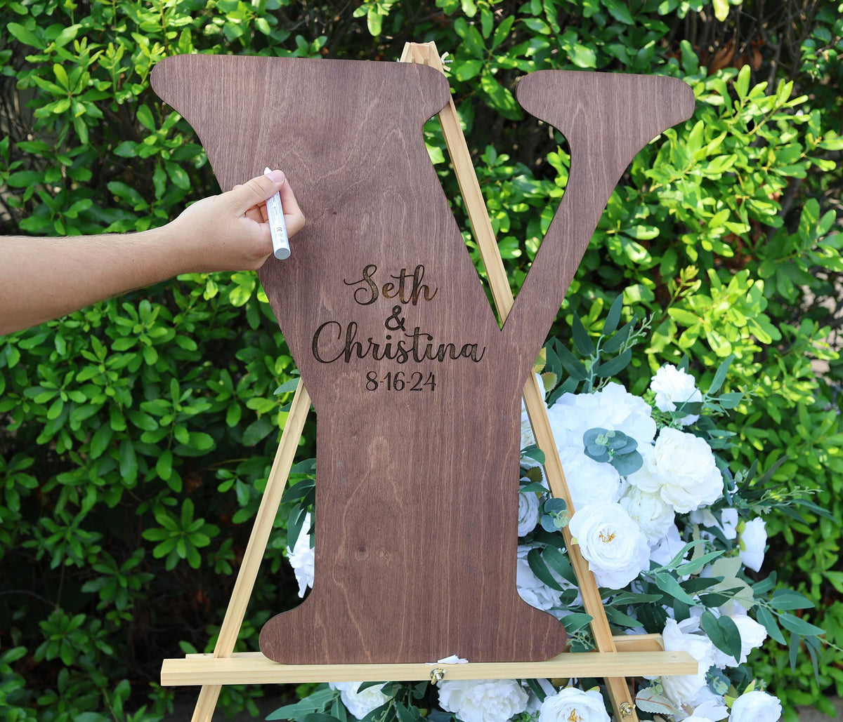 a wooden sign with a couple's initials on it