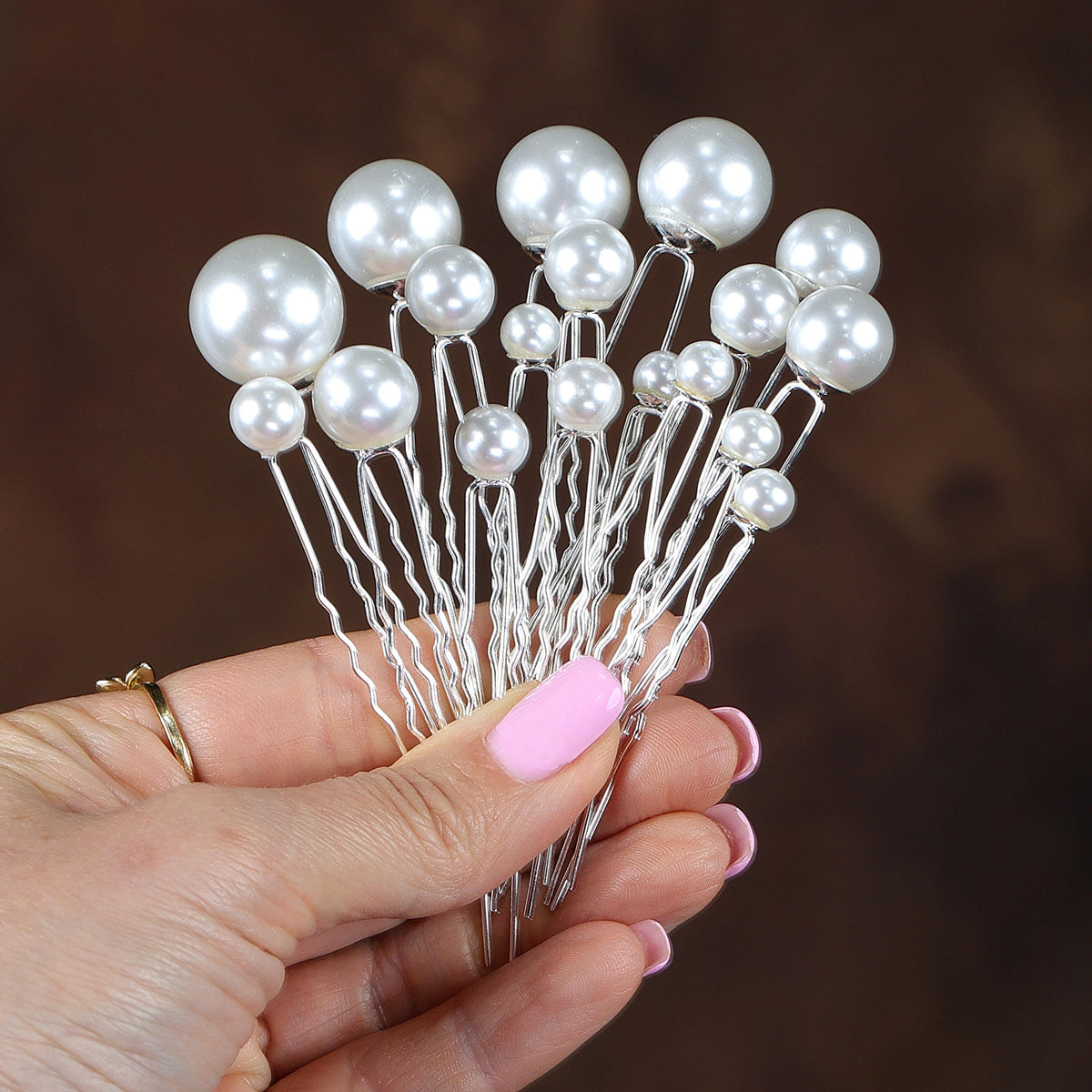 a hand holding a bunch of white pearls