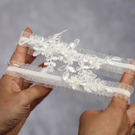 a woman is holding a piece of white lace