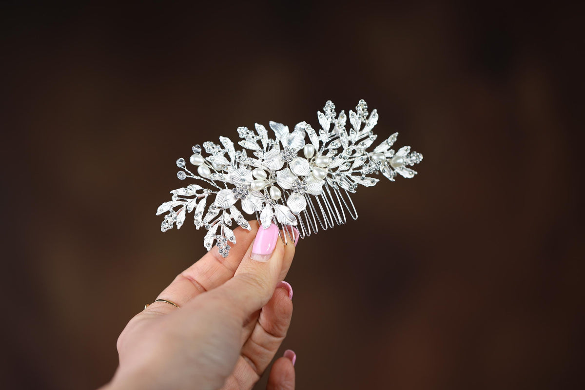 a woman's hand is holding a hair comb