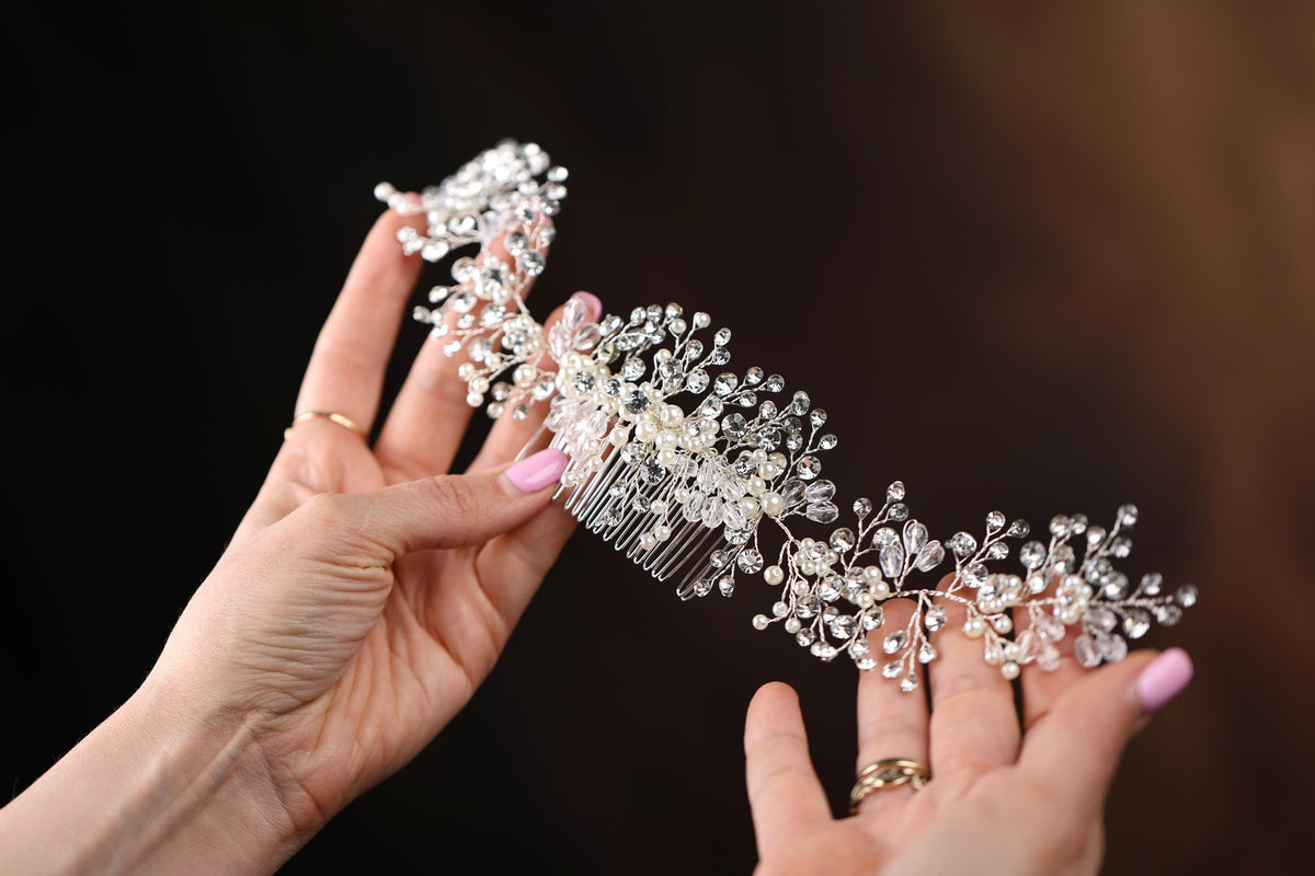 a close up of a person holding a hair comb