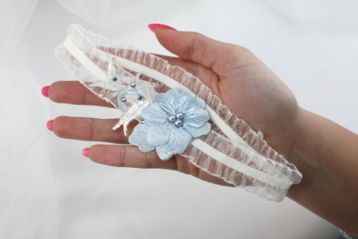 a woman's hand holding a piece of lace with a flower on it