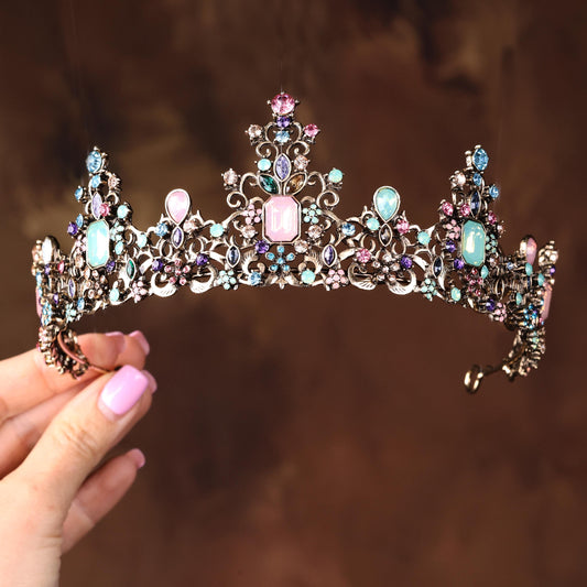 a woman holding a tiara in her hand