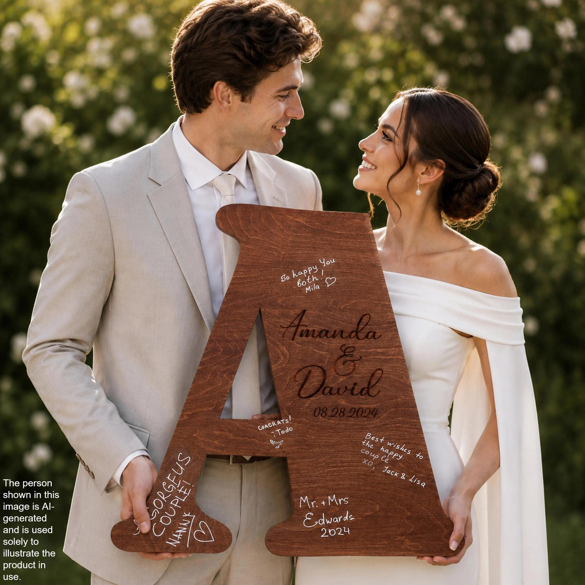 A man and a woman are holding a large wooden letter, which appears to be a wedding invitation or announcement. The man is wearing a suit, and the woman is wearing a white dress. They are smiling and looking at each other, suggesting a happy and loving relationship.