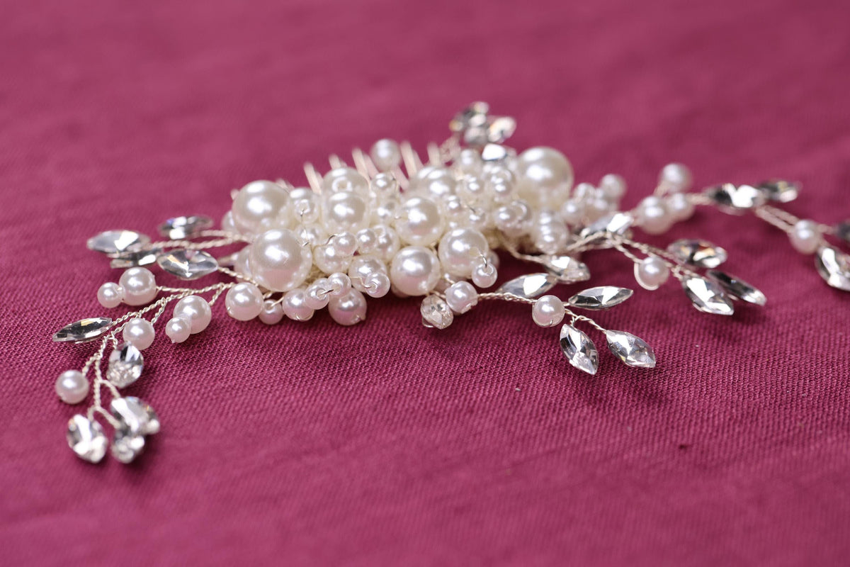 a close up of a hair comb with pearls