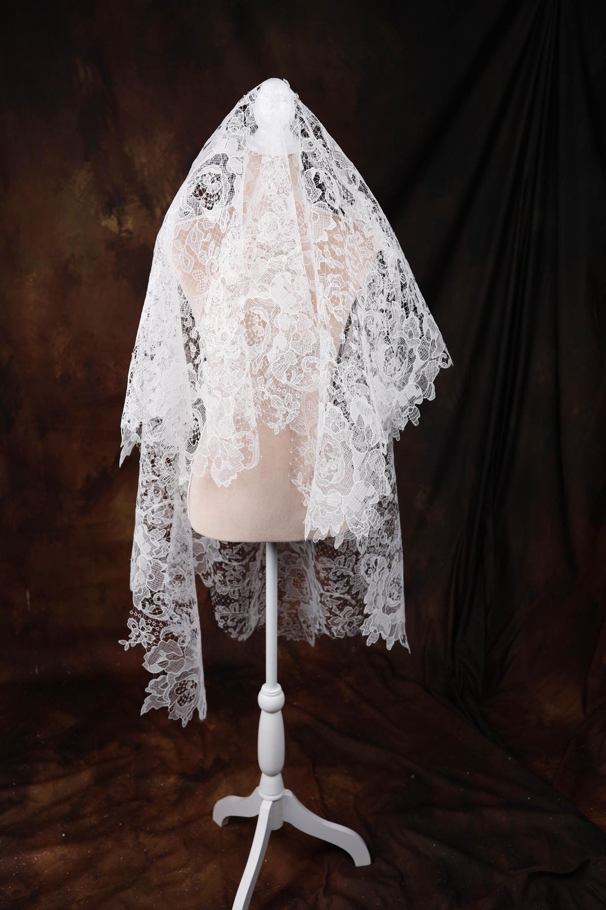 a white veil on a mannequin on a black background