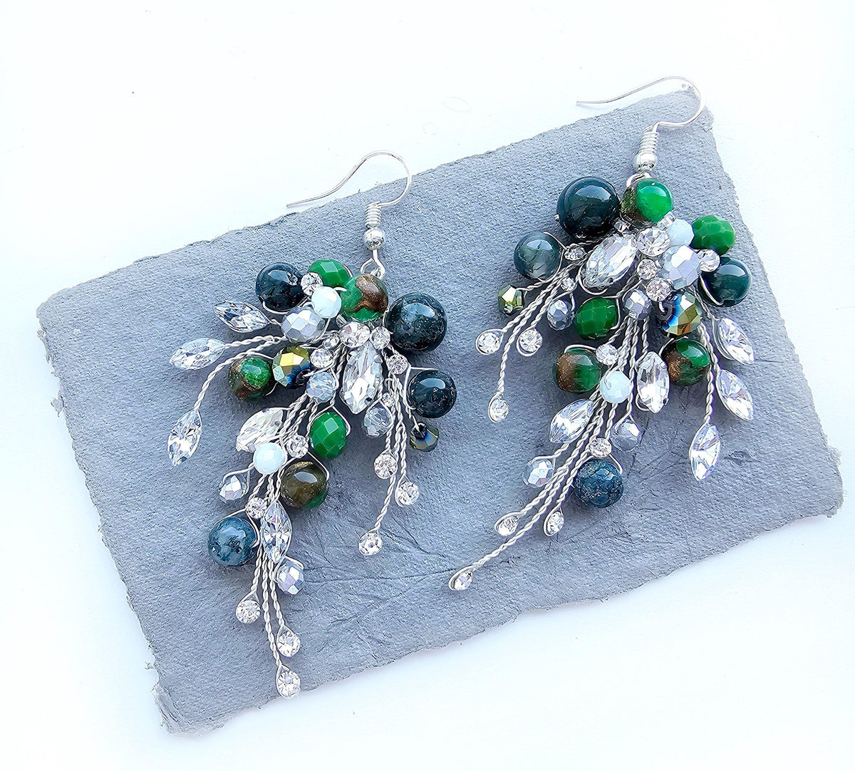 a pair of green, white and silver earrings