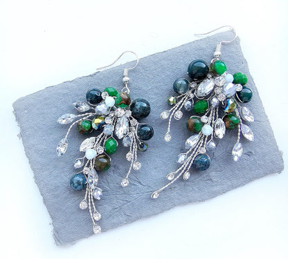 a pair of green, white and silver earrings