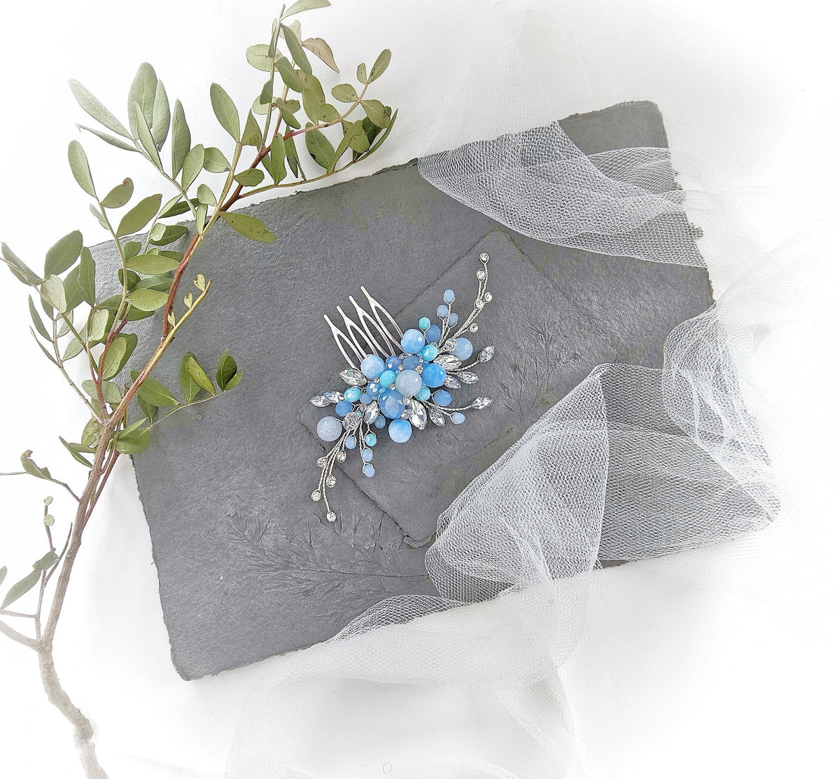a bridal hair comb with blue flowers and leaves