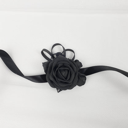 a black rose on a black ribbon on a white background