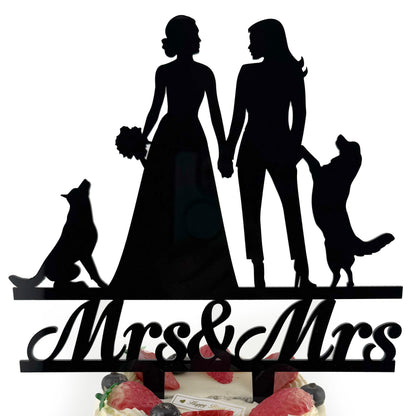A silhouette of a bride and groom holding hands, with a dog and a cake topper that says "Mrs & Mrs" below them.