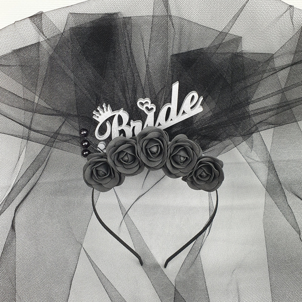 a black and white photo of roses on a veil